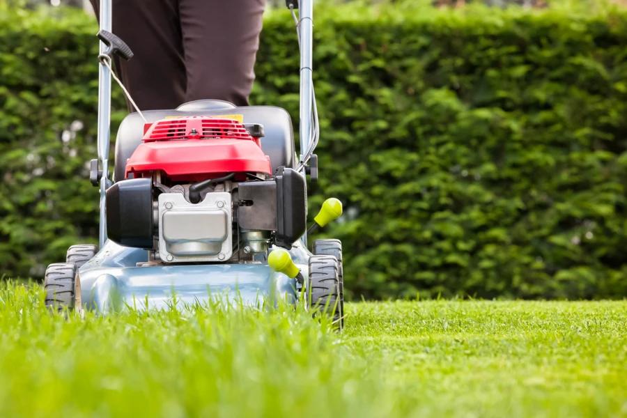 Landscaping professional pushing a lawn mower Summerglen, San Antonio, TX 78260